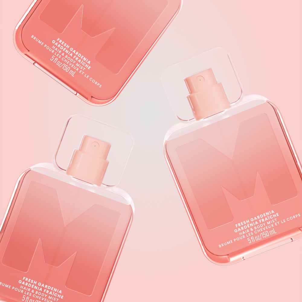 Two pink MONDAY Haircare Fresh Gardenia Hair and Body Mist bottles on a pink background.